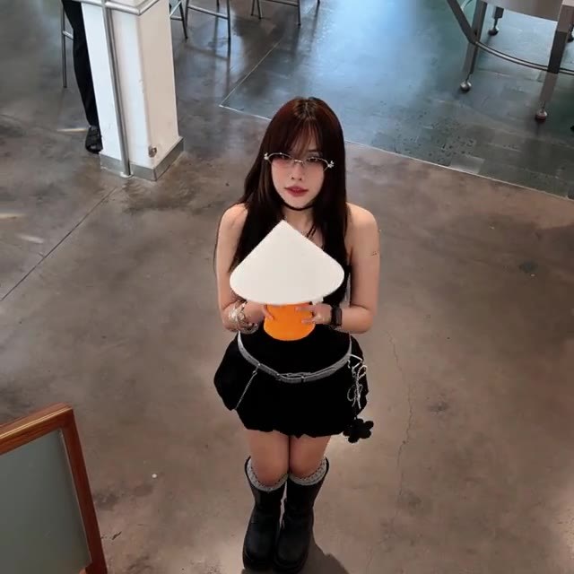 An Asa Studio team member holding a NOLA lamp at an event