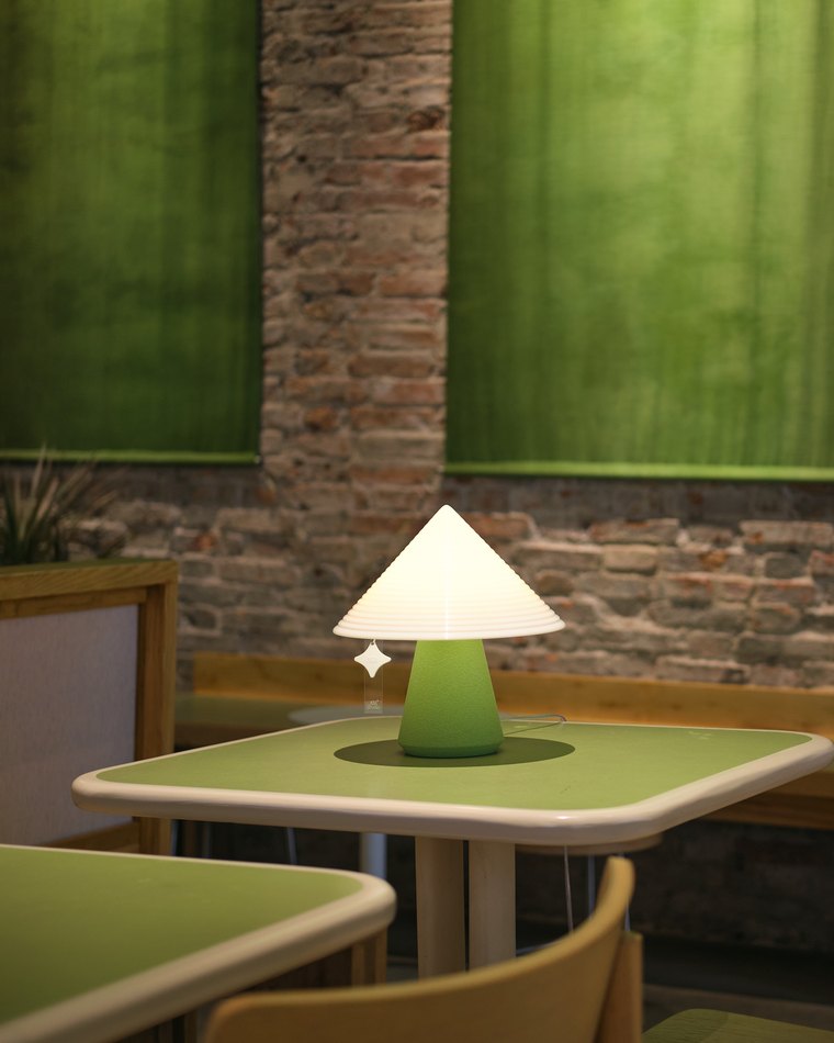 NOLA table lamp on concrete, lit by streaks of afternoon light